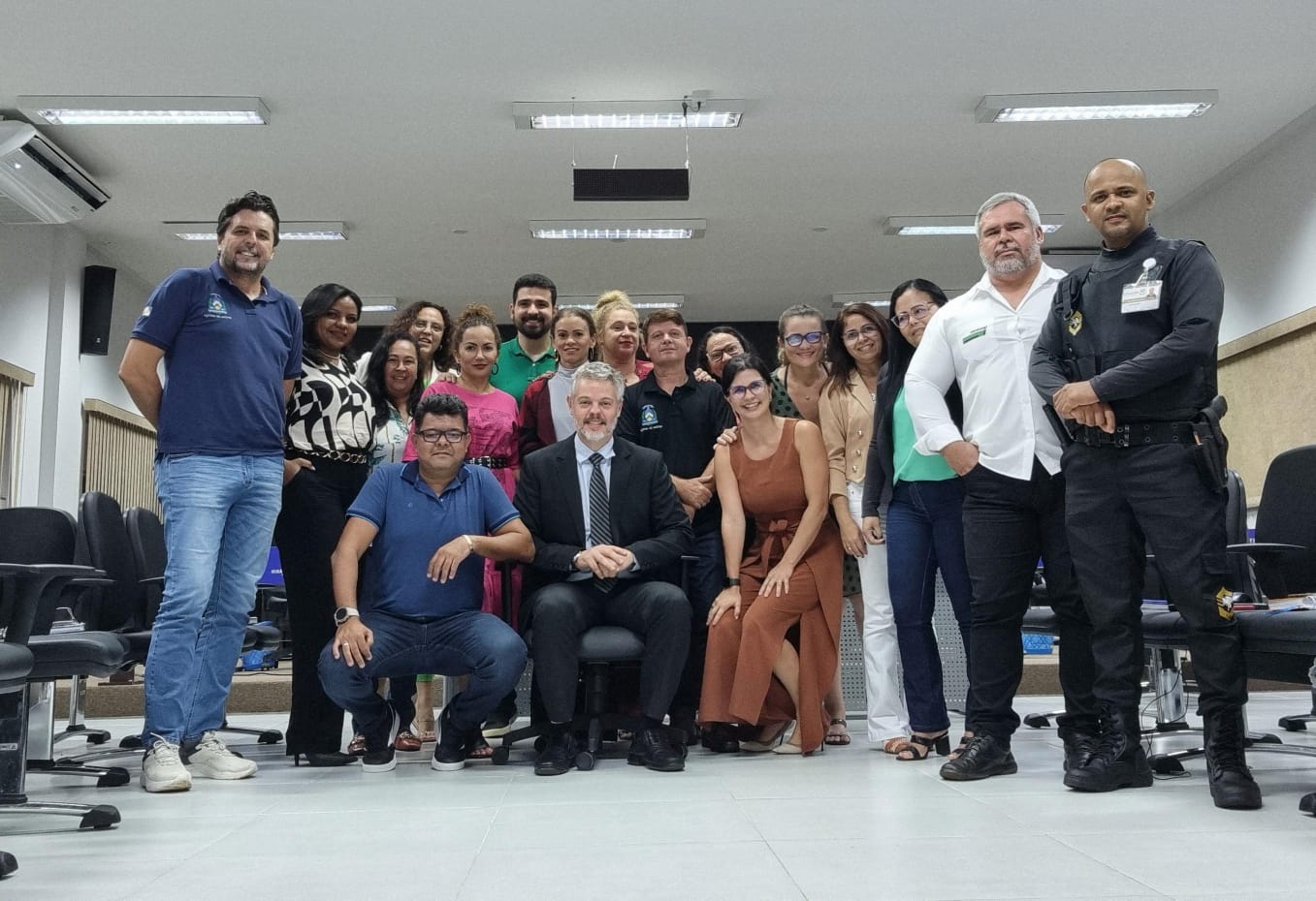 Juiz Ricardo Gagliardi (ao centro), cabelos e barba grisalhos, está sentado de terno escuro e camisa branca, ao lado da equipe da comarcaom equipe da Comarca de Miranorte
