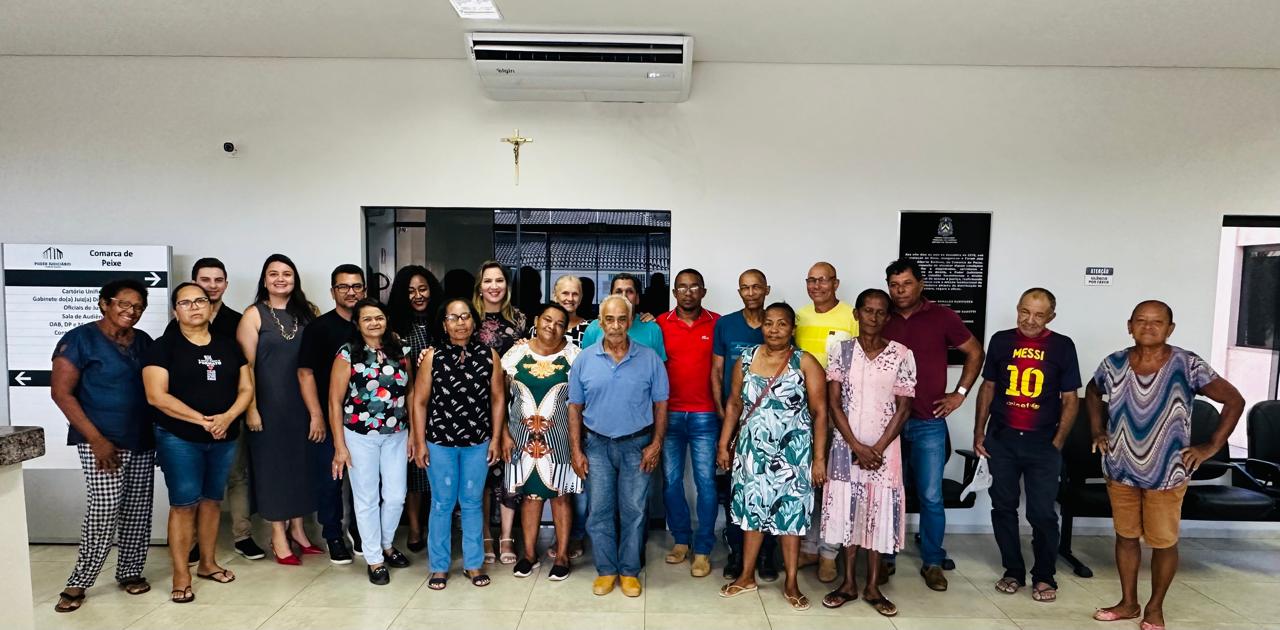 Homens e mulheres em pé em frente a uma parede branca