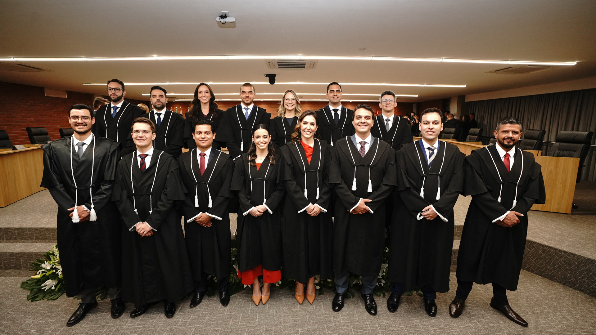 Os 15 novos juízes e juízas substitutos(as) do Poder Judiciário do Tocantins posam para foto oficial após a solenidade de posse coletiva, realizada no Tribunal Pleno. Vestidos com toga, os novos magistrados estão dispostos em duas fileiras no plenário do TJTO.