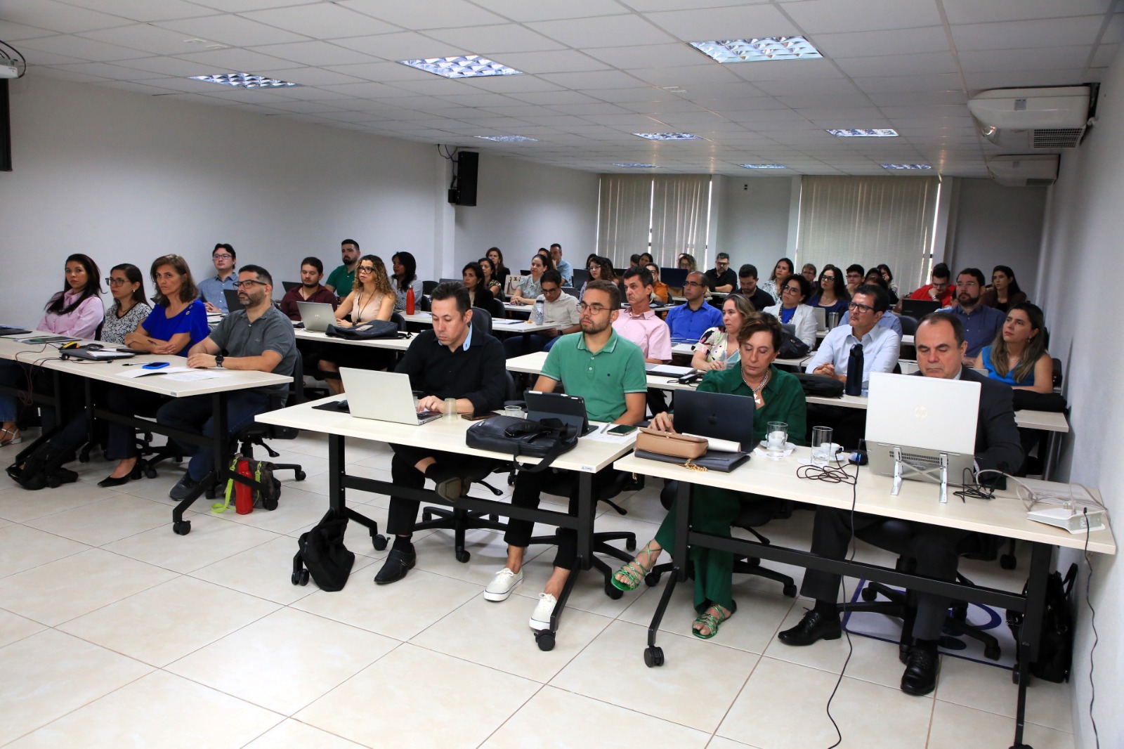 Alunos ao fundo assistem ao curso sobre Inteligência Artificial e ChatGPT